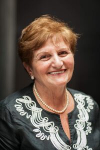 Rita Rubinstein, stands for a portrait with family by the Gravity sculpture in the U.S. Holocaust Memorial Museum